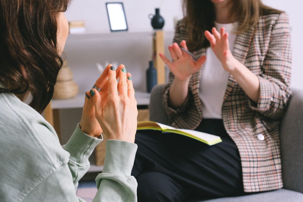 Two women sitting and talking face-to-face